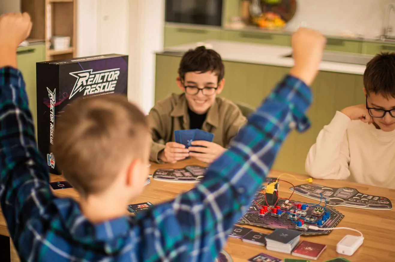 Players around a table mid-game of Reactor Rescue
