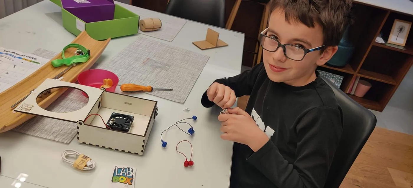 A Labbox workshop: children at tables building circuits with the kits