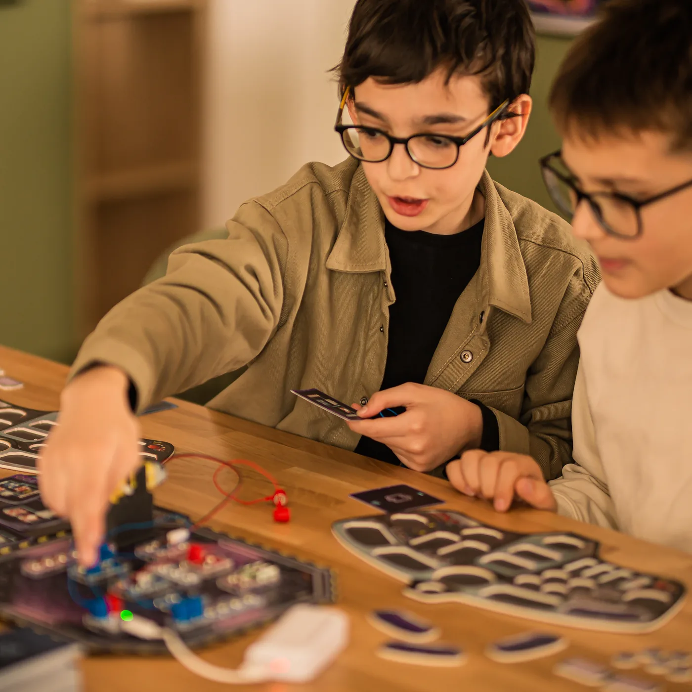 Two players mid-game at the Reactor Rescue board